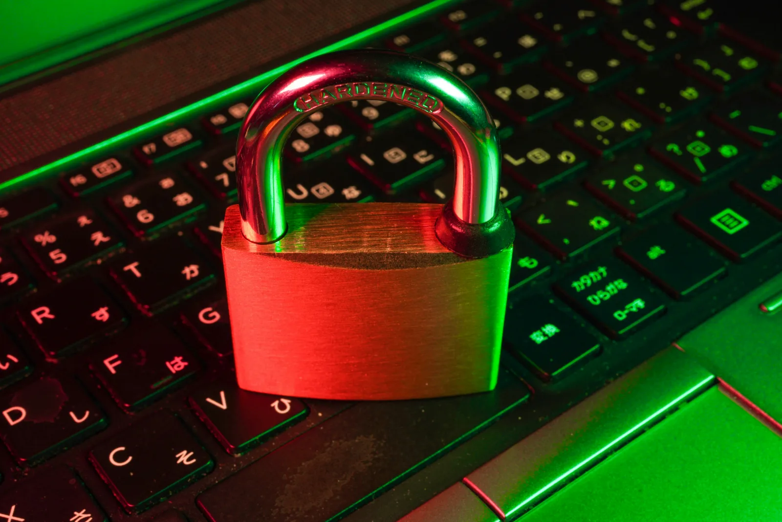 A red padlock resting on a black computer keyboard