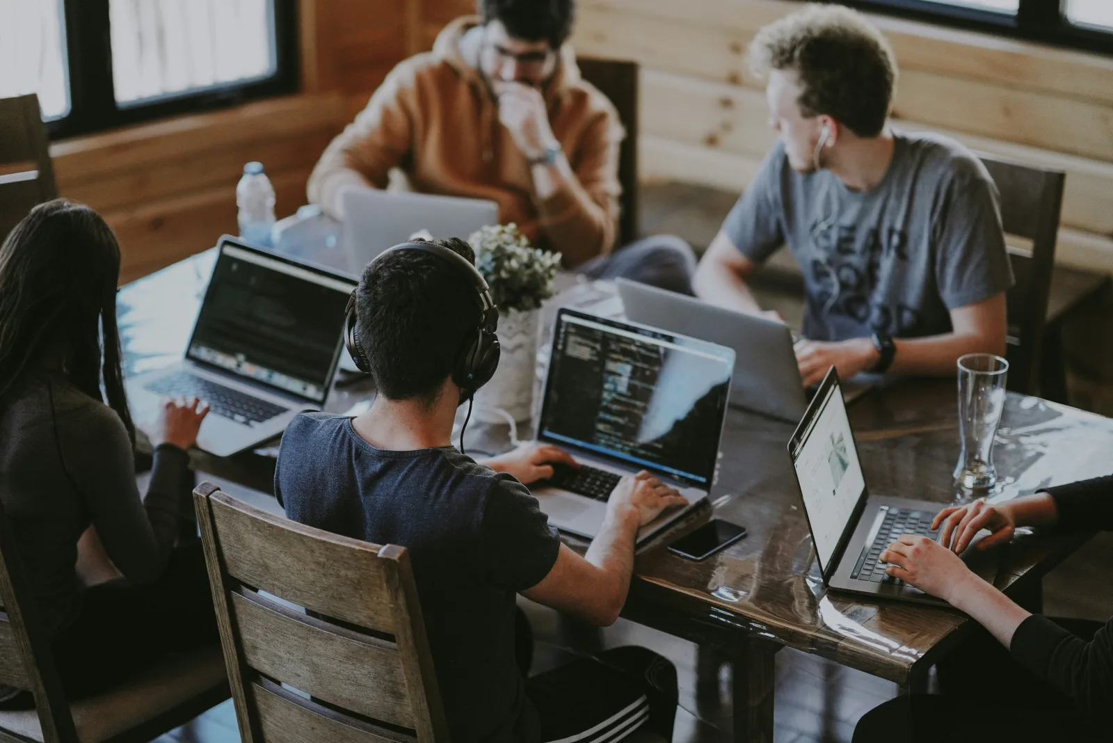 A group of people collaborating around laptops
