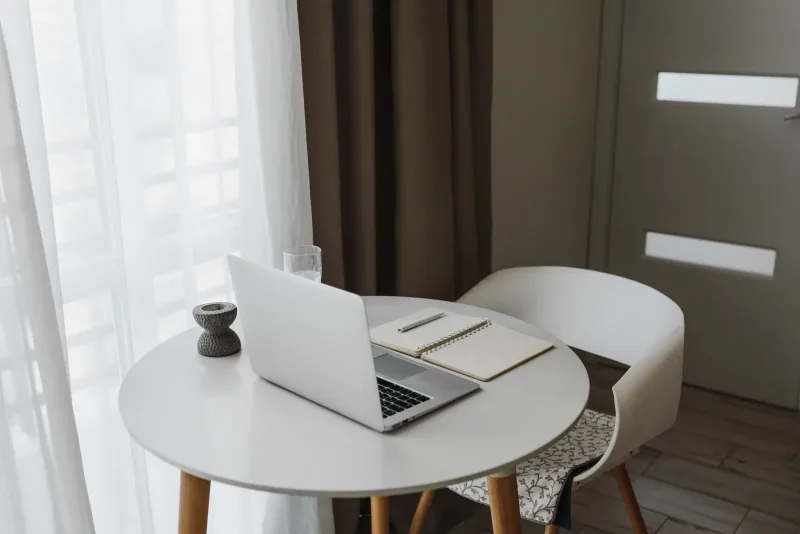 A tidy home-office desk with a laptop