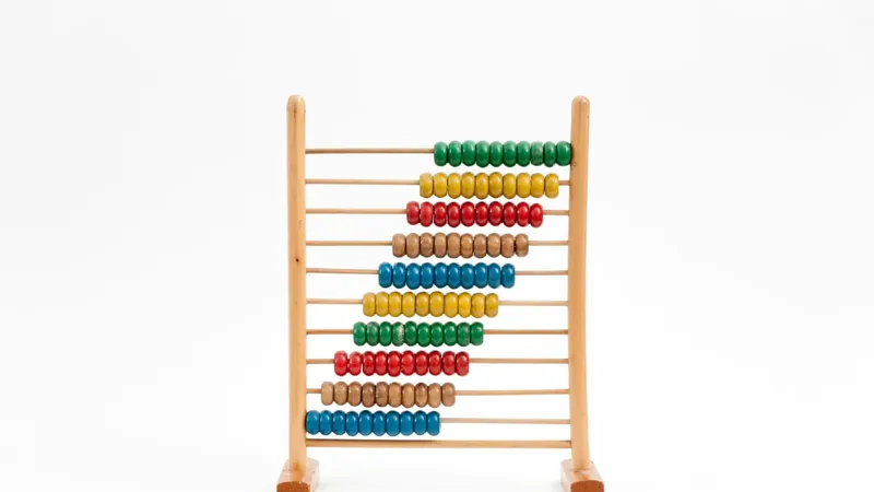 A wooden abacus with rows of multicolored counting beads